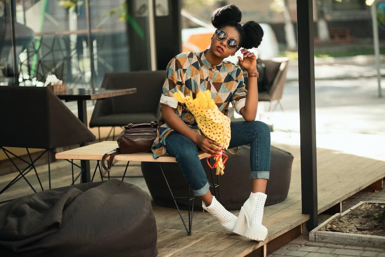 Two models wearing women's black cotton crewneck tee and off-white cotton crewneck tee.